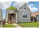 Charming gray home with a well-maintained lawn and inviting front porch at 202 Mckim Ave, Indianapolis, IN 46201