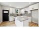 Bright kitchen with white cabinets, granite countertops, and stainless steel appliances at 202 Mckim Ave, Indianapolis, IN 46201