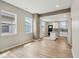 Open living area with wood floors and view into the modern white kitchen at 202 Mckim Ave, Indianapolis, IN 46201