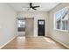 Open living room with wood floors, a ceiling fan, and sliding barn door at 202 Mckim Ave, Indianapolis, IN 46201