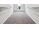 Walk-in closet with carpeted floor and closet rods on each side at 202 Mckim Ave, Indianapolis, IN 46201