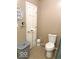 Functional bathroom featuring a toilet, laundry basket, and a clean, neutral color scheme at 212 Vasbinder Dr, Chesterfield, IN 46017