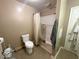 Cozy bathroom features a toilet and shower with white shower stall and neutral walls at 212 Vasbinder Dr, Chesterfield, IN 46017