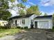 Charming single-story home with attached garage and a cozy front porch at 212 Vasbinder Dr, Chesterfield, IN 46017