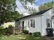 Charming home exterior featuring white siding, well-kept yard, and a cozy front porch at 212 Vasbinder Dr, Chesterfield, IN 46017
