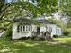 Charming single-story home with a cozy front porch and bay window at 212 Vasbinder Dr, Chesterfield, IN 46017