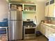 Functional kitchen with stainless steel appliances, including a refrigerator and gas range at 212 Vasbinder Dr, Chesterfield, IN 46017