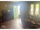 Living room featuring hardwood floors, neutral wall, and a green front door at 212 Vasbinder Dr, Chesterfield, IN 46017