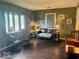 Cozy living room with hardwood floors and a large bay window, providing ample natural light at 212 Vasbinder Dr, Chesterfield, IN 46017