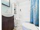 Clean bathroom features a vanity, shower-tub combo, and storage shelves at 2314 Walnut St, Anderson, IN 46016