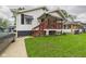 Charming home featuring a covered front porch with wooden railings and a well-maintained lawn at 2314 Walnut St, Anderson, IN 46016