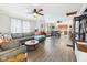 Open-concept living area with hardwood floors, ceiling fans, and seamless flow to the dining and kitchen spaces at 2314 Walnut St, Anderson, IN 46016