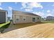 Backyard showing the home's siding, roof and rear-sliding glass doors at 2334 Black Rock Cir, Lebanon, IN 46052