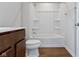 A clean bathroom featuring a vanity, toilet, and a shower-tub combination with white fixtures at 2334 Black Rock Cir, Lebanon, IN 46052