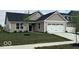 Charming single-story home featuring a two-car garage, a blue door, and a well-manicured front lawn at 2334 Black Rock Cir, Lebanon, IN 46052