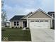 Charming single-story home featuring a two-car garage, a blue door, and a well-manicured front lawn at 2334 Black Rock Cir, Lebanon, IN 46052