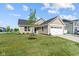 Inviting one-story home featuring a tidy lawn, a blue entry door, and an attached two-car garage at 2334 Black Rock Cir, Lebanon, IN 46052