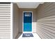Bright blue front door with a window, and a 'Welcome' mat at the entrance at 2334 Black Rock Cir, Lebanon, IN 46052