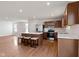 Open kitchen and living area with stainless steel appliances, a central island, and ample natural light at 2334 Black Rock Cir, Lebanon, IN 46052