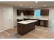 Spacious kitchen features dark wood cabinets, a center island, and ample countertop space at 2334 Black Rock Cir, Lebanon, IN 46052