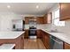 Bright kitchen with stainless steel appliances, countertops, and island with seating, ready for cooking at 2334 Black Rock Cir, Lebanon, IN 46052