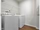 Functional laundry room with washer, dryer, and wire shelving for storage at 2334 Black Rock Cir, Lebanon, IN 46052
