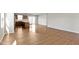 Bright living room with hardwood floors, open layout, and view of the kitchen with stainless appliances at 2334 Black Rock Cir, Lebanon, IN 46052