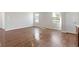A bright, open living room with wood-look flooring and a view of the windows and walls at 2334 Black Rock Cir, Lebanon, IN 46052