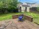 Backyard featuring a shed, small brick walls, and a brick-paved patio at 2350 Harvest Moon Dr, Greenwood, IN 46143