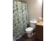 Bathroom featuring a white toilet, vanity with a granite counter, and a shower with a leaf-patterned curtain at 2350 Harvest Moon Dr, Greenwood, IN 46143