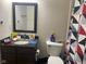 Bathroom featuring a dark vanity, mirror, toilet, and decorative shower curtain with a geometric pattern at 2350 Harvest Moon Dr, Greenwood, IN 46143