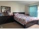 Bedroom featuring carpeted floor, window with curtains, dresser, and bed with flower-patterned bedding at 2350 Harvest Moon Dr, Greenwood, IN 46143