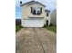 Inviting two-story home featuring an attached two-car garage and driveway at 2350 Harvest Moon Dr, Greenwood, IN 46143