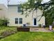 Home's exterior featuring the back yard with a patio, a chair, and the home's pale yellow siding at 2350 Harvest Moon Dr, Greenwood, IN 46143