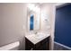Well-lit bathroom features a granite vanity with a large mirror, stainless steel fixtures, and painted accent wall at 2628 Lamar Dr, Whitestown, IN 46075