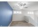 Bedroom featuring a large blue accent wall, ceiling fan, and natural light from the window at 2628 Lamar Dr, Whitestown, IN 46075
