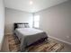 Neutral bedroom boasts soft natural light from the bright window and comfortable queen bed at 2628 Lamar Dr, Whitestown, IN 46075