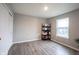 This room features wood flooring, a window, a closet, and a shelving unit for storage and is well-lit at 2628 Lamar Dr, Whitestown, IN 46075
