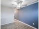 Bedroom featuring a large blue accent wall, ceiling fan, and natural light from the window at 2628 Lamar Dr, Whitestown, IN 46075