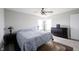 This bedroom is well lit with wood flooring, a ceiling fan, a dresser, two windows, and two bedside lamps at 2628 Lamar Dr, Whitestown, IN 46075