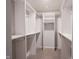 Custom walk in closet with lots of shelves and clothing racks at 2628 Lamar Dr, Whitestown, IN 46075