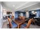 Open concept dining room features wood floors, blue accent wall and table with seating for six at 2628 Lamar Dr, Whitestown, IN 46075