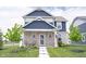 Charming two-story home with a stone facade, well-manicured lawn, and inviting front porch at 2628 Lamar Dr, Whitestown, IN 46075