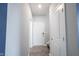Hallway with gray walls, luxury vinyl plank flooring, and white doors at 2628 Lamar Dr, Whitestown, IN 46075