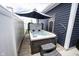 Outdoor patio features a luxurious hot tub beneath a shade umbrella and dark blue exterior at 2628 Lamar Dr, Whitestown, IN 46075