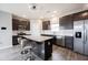 Modern kitchen with stainless steel appliances, dark cabinets, and a spacious island with barstool seating at 2628 Lamar Dr, Whitestown, IN 46075