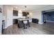 Open kitchen with island, stainless steel appliances, and view into adjoining room at 2628 Lamar Dr, Whitestown, IN 46075