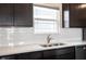 Close-up of the kitchen area with a stainless steel sink, white subway tile backsplash, and modern cabinets at 2628 Lamar Dr, Whitestown, IN 46075