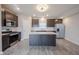 Bright kitchen featuring stainless appliances, an island, and gray wood flooring at 2628 Lamar Dr, Whitestown, IN 46075