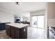 Open floor plan with kitchen island, stainless appliances, and adjoining dining and living space at 2628 Lamar Dr, Whitestown, IN 46075